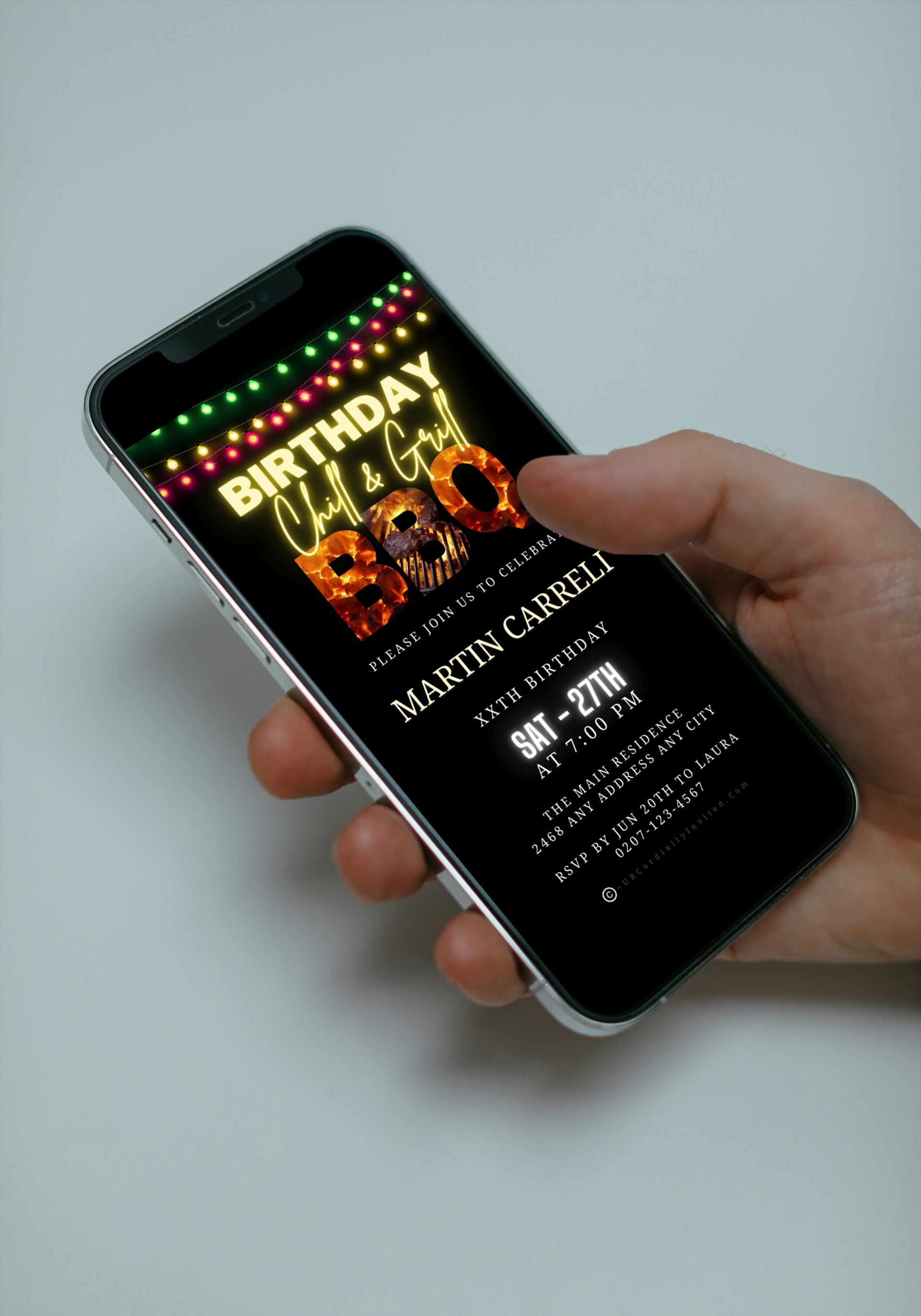 Hand holding a smartphone displaying an animated BBQ Flaming Grill Birthday digital video party invitation, customizable using Canva for text, email, and social media sharing.