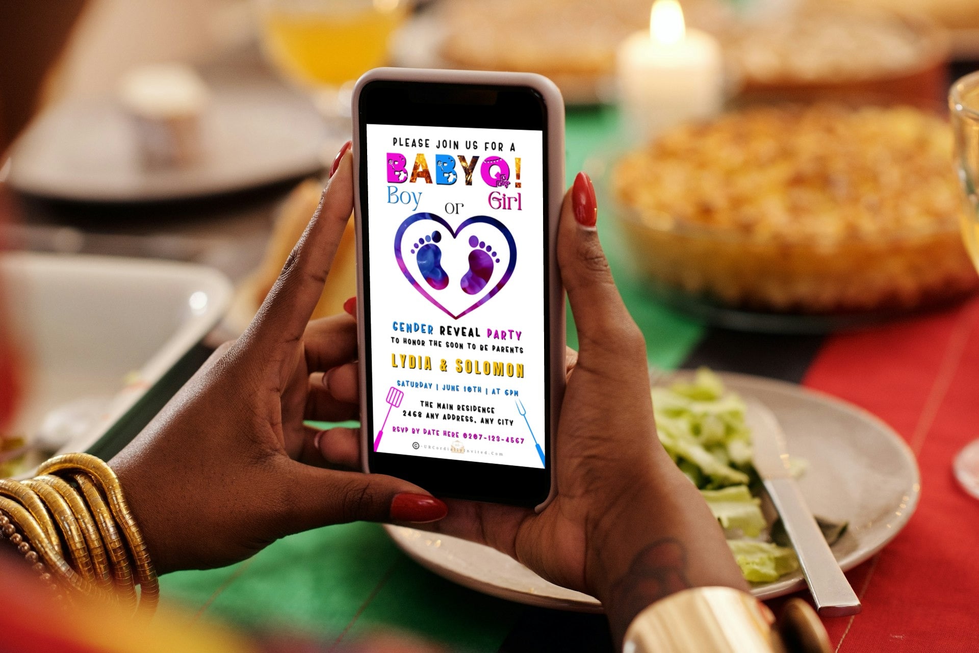 Person holding a smartphone displaying a customizable BABYQ Feet In Heart digital gender reveal video invite.