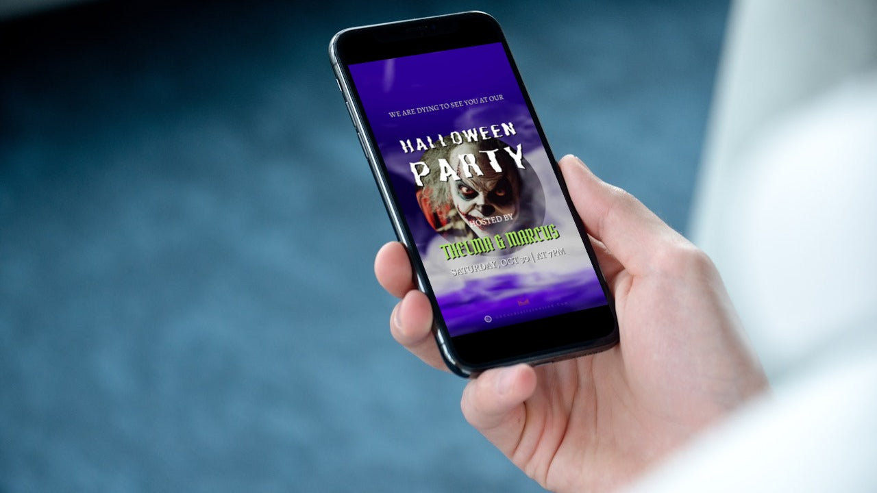 A hand holding a smartphone displaying the Misty Purple Smoke Pumpkin Halloween Party Video Invite.