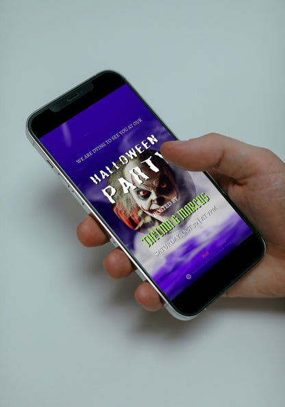 Hand holding a cell phone displaying Misty Purple Smoke Pumpkin Halloween Party Video Invite, featuring animated pumpkin and purple smoke for customizable digital invitations.