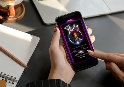 Person holding a phone displaying a 30th Birthday Video Invitation with a gold oval photo frame, perfect for elegant milestone celebrations.