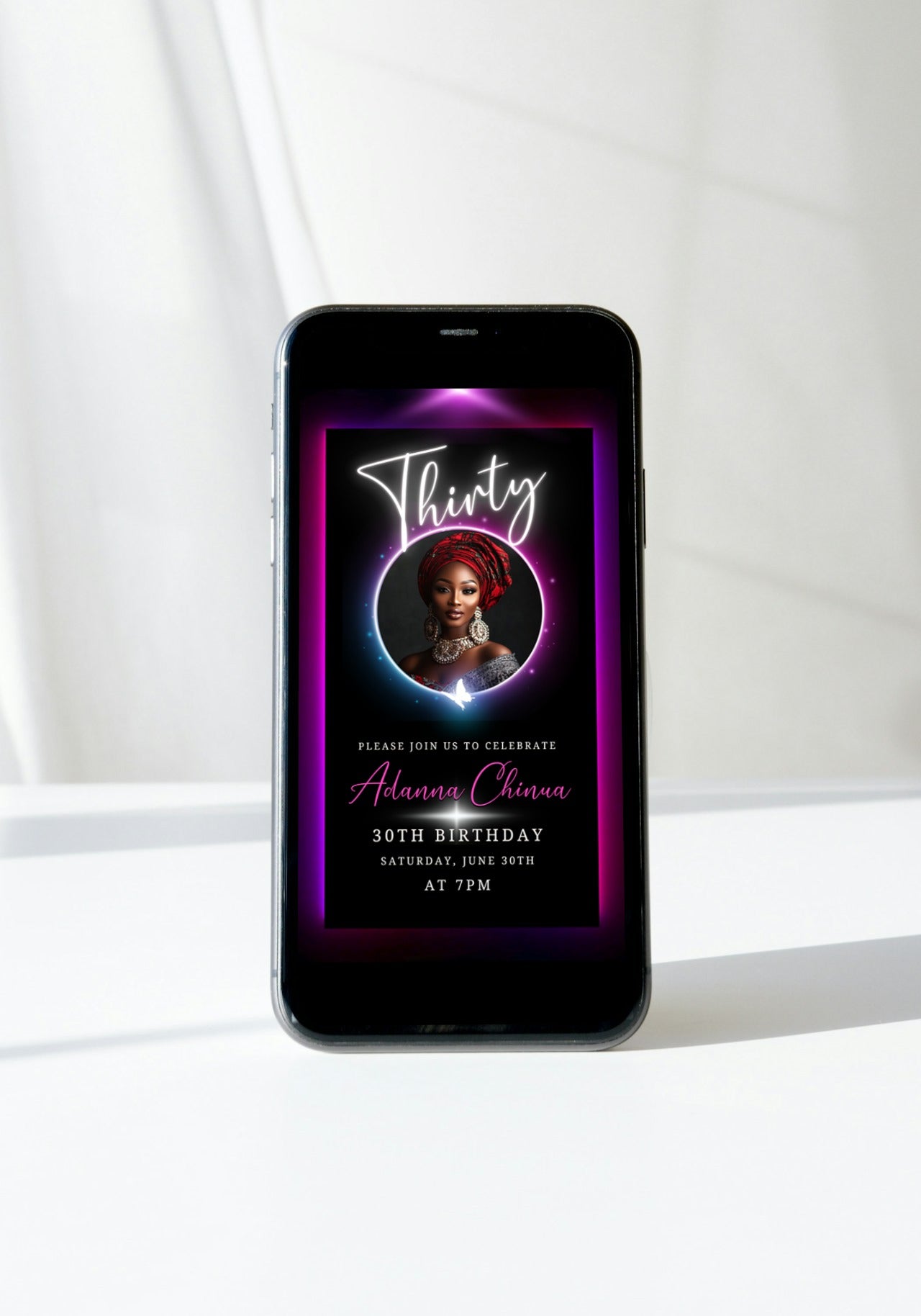 30th Birthday Video Invitation - Pink & Purple Oval Photo Frame Animated Invite displayed on a smartphone, featuring a woman's photo in a red head wrap.