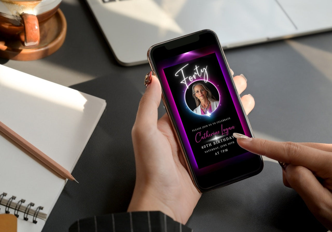 Person holding a phone displaying a 40th Birthday Video Invitation with a pink and purple oval photo frame, highlighting a sophisticated digital invitation design.