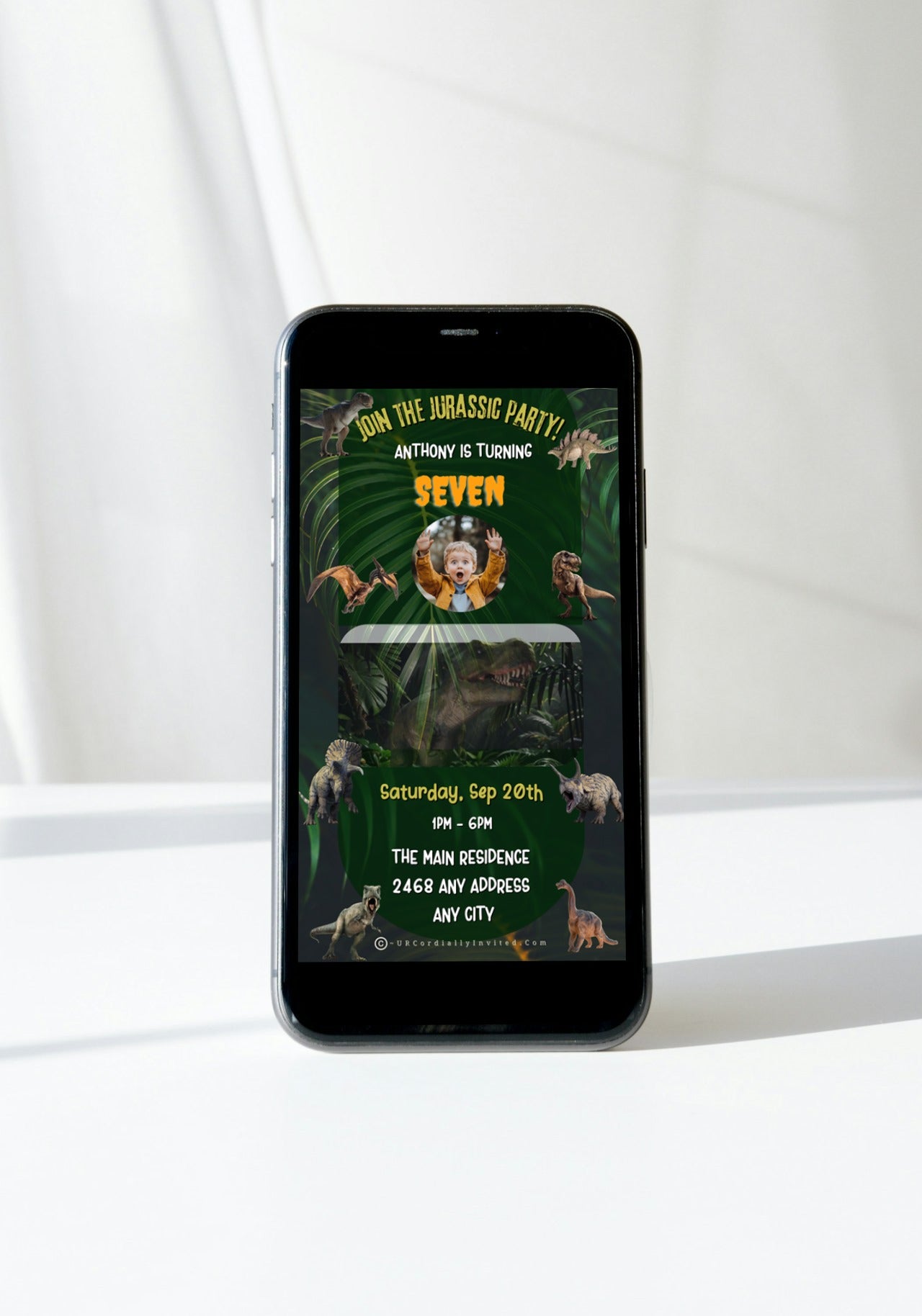 Dinosaur Birthday Video Invitation displayed on a mobile phone, featuring animated dinosaurs, perfect for a Jurassic-themed celebration. Customizable via Canva for digital sharing.