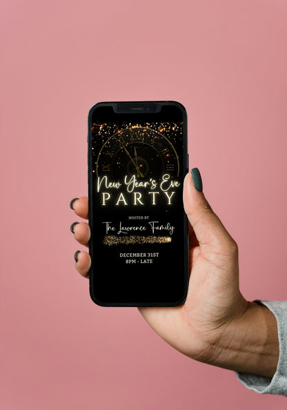 Hand holding a smartphone displaying the Countdown Clock New Year’s Eve Party Animated Invitation template, customizable via Canva for digital sharing.