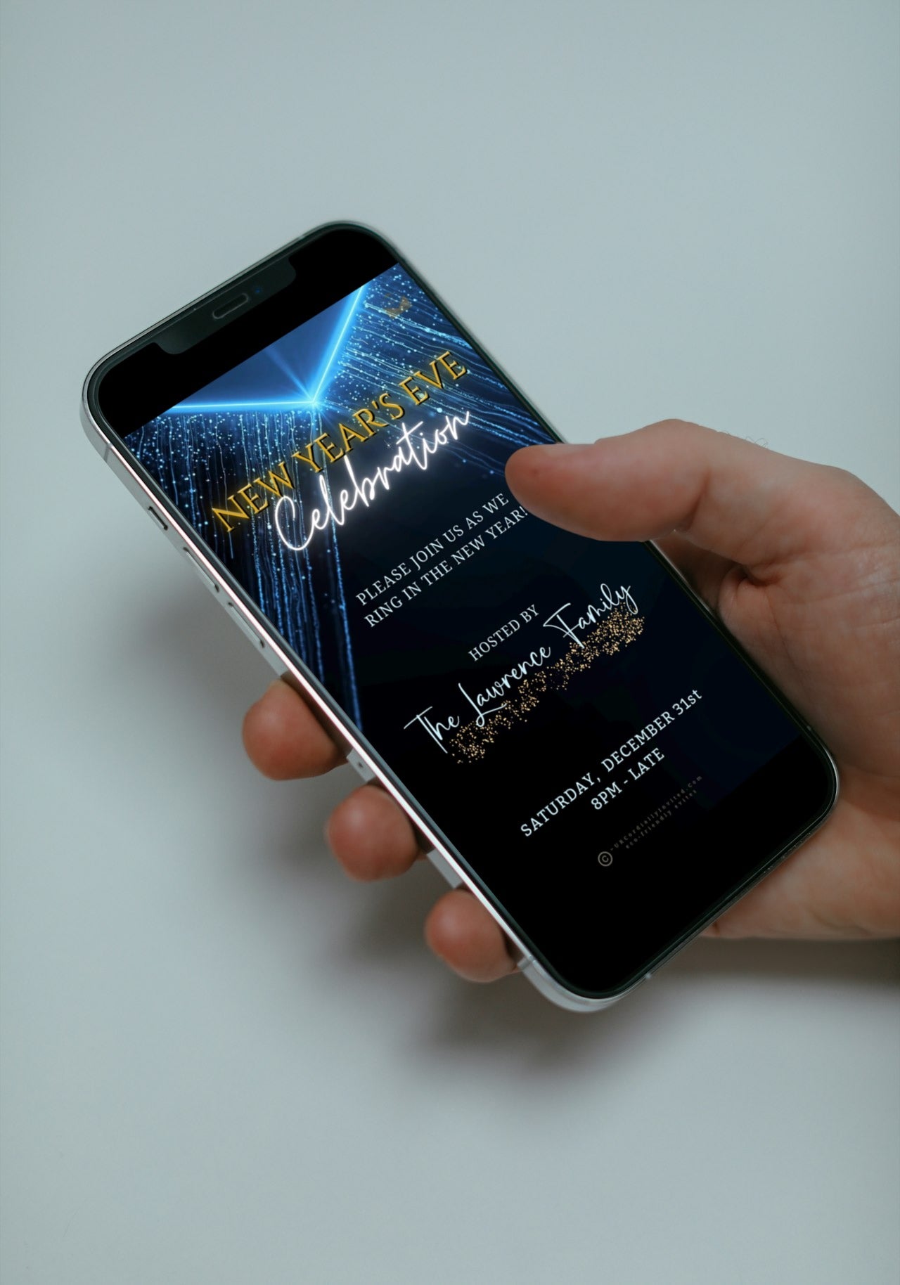 Person holding phone with Dazzling Blue Gold New Year’s Eve Celebration Video Invitation displayed, showcasing festive animations and customization options for elegant party invitations.