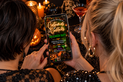Two women look at a Halloween party video invitation on a phone, surrounded by festive orange and black decor.