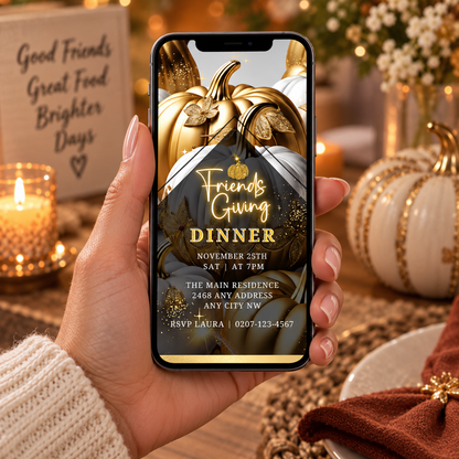 Phone displaying a Friendsgiving dinner invitation with gold pumpkin design, surrounded by autumn candles and pumpkins.